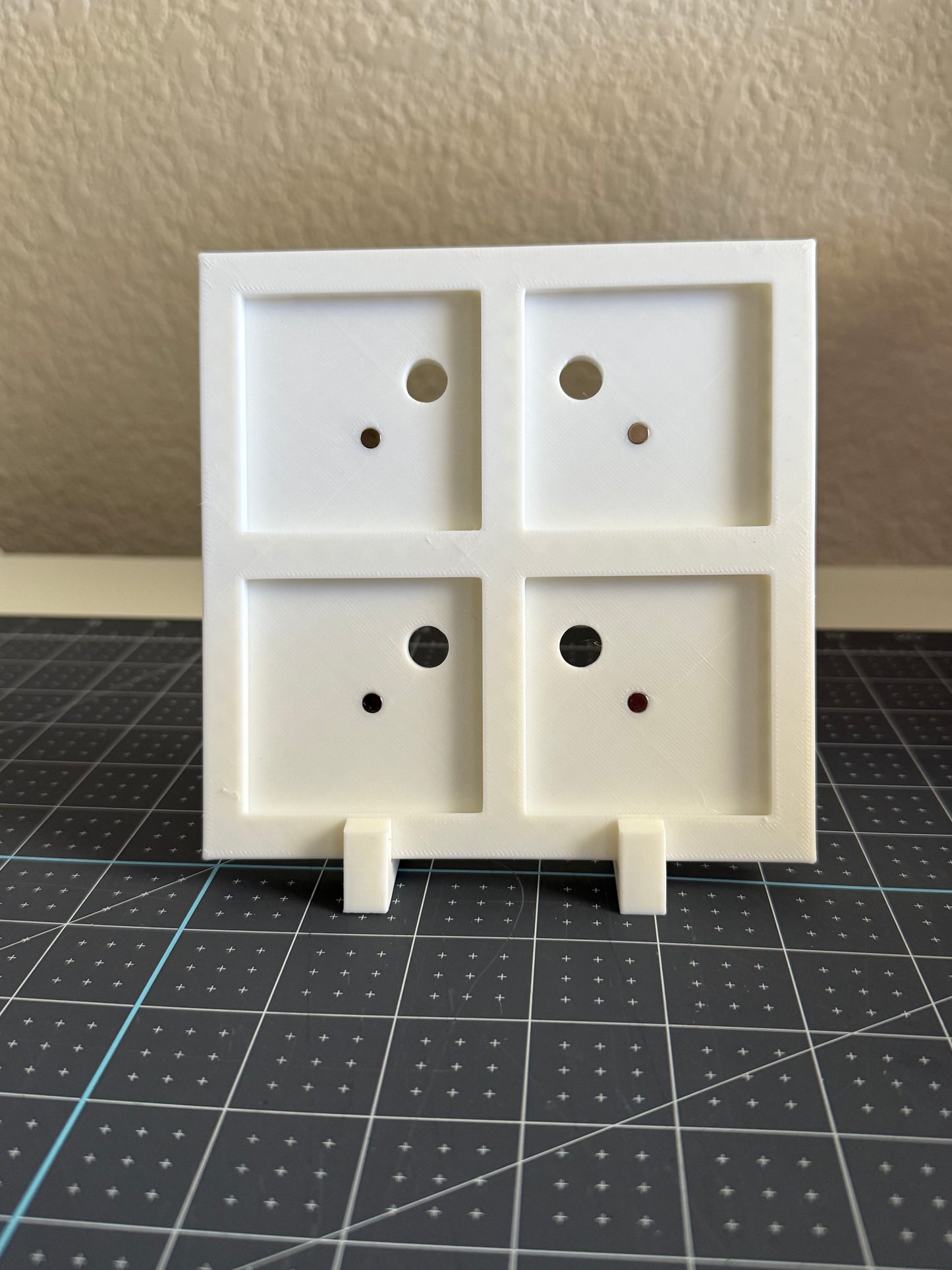 White 3D Printed frame with holes to remove photo magnets.